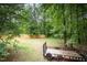 Fenced-in backyard with mature trees and a trailer at 25 Williamston Ridge Dr, Youngsville, NC 27596