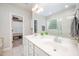 Bathroom features a double sink vanity, with a large mirror, a walk-in shower, a jetted tub, and linen closet at 25 Williamston Ridge Dr, Youngsville, NC 27596