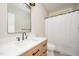 Modern bathroom with light wood vanity, a sleek mirror and fixtures, plus a shower with glass door and white curtain at 25 Williamston Ridge Dr, Youngsville, NC 27596