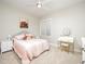 Charming bedroom with plush carpet, complemented by soft pink bedding, a vanity, and lots of natural light at 25 Williamston Ridge Dr, Youngsville, NC 27596