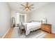 Bright bedroom with wood flooring, ceiling fan, neutral paint, and metal bed frame with updated furnishings at 25 Williamston Ridge Dr, Youngsville, NC 27596