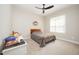 Cozy bedroom offers neutral colors, ceiling fan, carpet, and a bright window at 25 Williamston Ridge Dr, Youngsville, NC 27596