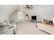 Bright bonus room with a ceiling fan, large window, desk, sofa, and TV at 25 Williamston Ridge Dr, Youngsville, NC 27596