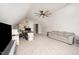 Bonus room with neutral walls, carpet, sofa, ceiling fan, and desk setup at 25 Williamston Ridge Dr, Youngsville, NC 27596