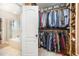 Spacious walk-in closet provides ample storage with custom shelves, hanging rods and has access to jetted tub at 25 Williamston Ridge Dr, Youngsville, NC 27596