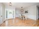 Bright dining room with hardwood floors, decorative lighting, and stylish wainscoting at 25 Williamston Ridge Dr, Youngsville, NC 27596