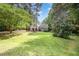 Charming home featuring a spacious lawn with mature trees and manicured landscaping at 25 Williamston Ridge Dr, Youngsville, NC 27596