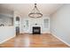 Open living space with hardwood floors, a fireplace, and lots of natural light from windows at 25 Williamston Ridge Dr, Youngsville, NC 27596