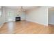 Cozy living room highlighted by a fireplace, large windows, and natural hardwood flooring at 25 Williamston Ridge Dr, Youngsville, NC 27596