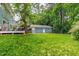View of the home's large backyard, showcasing a deck, garage, and green space at 2517 Medway Dr, Raleigh, NC 27608