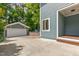Backyard view featuring a detached garage and spacious concrete area, perfect for parking at 2517 Medway Dr, Raleigh, NC 27608