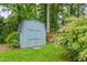 A well-maintained backyard shed surrounded by lush greenery and trees at 2517 Medway Dr, Raleigh, NC 27608