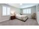 Bright bedroom features neutral tones, a comfortable bed, and two windows for natural light at 2517 Medway Dr, Raleigh, NC 27608