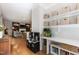 Open bonus room with hardwood floors, built-in shelving, and a toy kitchen at 2517 Medway Dr, Raleigh, NC 27608