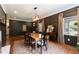 Warm dining room with a wooden table, dark walls, and natural light from the window at 2517 Medway Dr, Raleigh, NC 27608