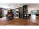 Elegant dining room with hardwood floors, fireplace, stylish light fixture, and open access to the living area at 2517 Medway Dr, Raleigh, NC 27608