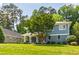 Attractive two-story home with a classic front porch, complemented by a well-maintained lawn and lush greenery at 2517 Medway Dr, Raleigh, NC 27608