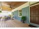 Relaxing front porch featuring a cozy seating area, elegant wooden ceiling, and charming brick facade at 2517 Medway Dr, Raleigh, NC 27608
