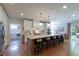 Spacious kitchen features a large island with seating, stainless steel appliances, and a view of the laundry area at 2517 Medway Dr, Raleigh, NC 27608