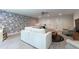 Open-concept living room with unique wallpaper and neutral furnishings at 2517 Medway Dr, Raleigh, NC 27608
