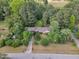 Aerial view of home showing mature trees surrounding the home, and long driveway at 2608 Knightwood Rd, Fuquay Varina, NC 27526
