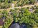 Aerial view of the house surrounded by lush trees in a quiet neighborhood near a lake at 2608 Knightwood Rd, Fuquay Varina, NC 27526