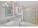 Bathroom features pink walls, chandelier lighting, and a shower with gold trim at 2608 Knightwood Rd, Fuquay Varina, NC 27526