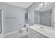 Bright bathroom featuring a shower/tub combo with sliding doors, toilet, vanity, and a large mirror at 2608 Knightwood Rd, Fuquay Varina, NC 27526