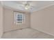 Bedroom with carpet, ceiling fan, and window with white curtains at 2608 Knightwood Rd, Fuquay Varina, NC 27526