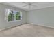 Bedroom with neutral carpet, ceiling fan, and large window at 2608 Knightwood Rd, Fuquay Varina, NC 27526