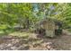 Backyard chicken coop near a chain link fence in a wooded yard at 2608 Knightwood Rd, Fuquay Varina, NC 27526