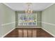 Elegant dining room with chandelier and view of the landscaped front yard at 2608 Knightwood Rd, Fuquay Varina, NC 27526
