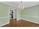 Elegant dining room with chandelier and view of the landscaped front yard at 2608 Knightwood Rd, Fuquay Varina, NC 27526