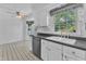 Cozy kitchen features black countertops, stainless steel dishwasher, and a dining nook at 2608 Knightwood Rd, Fuquay Varina, NC 27526