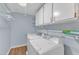Functional laundry room with washer, dryer, and shelving at 2608 Knightwood Rd, Fuquay Varina, NC 27526