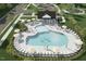 Aerial view of the community pool, complete with ample seating, umbrellas, and a playground at 2628 Pivot Ridge Dr, Raleigh, NC 27616