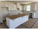 Bright kitchen featuring white cabinets, subway tile backsplash, and a large center island at 2628 Pivot Ridge Dr, Raleigh, NC 27616