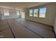 Open-concept living space with multiple windows and access to the backyard at 2628 Pivot Ridge Dr, Raleigh, NC 27616