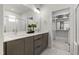 Modern bathroom with dual vanity, subway tile shower, and walk-in closet at 270 Wendover Pkwy, Pittsboro, NC 27312
