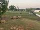 Spacious, fenced dog park with lush green grass and a convenient access gate at 270 Wendover Pkwy, Pittsboro, NC 27312
