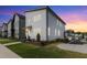 A modern home featuring stylish architecture, well-maintained lawn, and a vibrant sunset backdrop at 270 Wendover Pkwy, Pittsboro, NC 27312