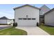 Side view of the garage with clean landscaping and a modern concrete driveway at 270 Wendover Pkwy, Pittsboro, NC 27312
