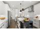 Modern kitchen with white cabinets, stainless steel appliances, and a central island at 270 Wendover Pkwy, Pittsboro, NC 27312