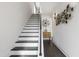 Modern staircase with dark wood treads, white risers, and unique wall decor at 270 Wendover Pkwy, Pittsboro, NC 27312