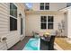 Back patio features a rug, outdoor furniture, and a door leading into the home at 2737 Casper Creek Ln, Raleigh, NC 27616