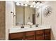 Spacious bathroom boasts double sinks, wood cabinets, and decorative lighting at 2737 Casper Creek Ln, Raleigh, NC 27616