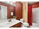 Bathroom features decorative wallpaper, vanity, toilet, and shower with curtain at 2737 Casper Creek Ln, Raleigh, NC 27616