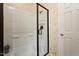 Tiled shower behind a glass door, and decorated with patterned wallpaper at 2737 Casper Creek Ln, Raleigh, NC 27616