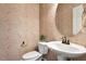 Charming half bathroom boasts decorative wallpaper, toilet, and pedestal sink at 2737 Casper Creek Ln, Raleigh, NC 27616