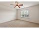 Bedroom with a window and neutral carpet features a ceiling fan and lots of natural light at 2737 Casper Creek Ln, Raleigh, NC 27616